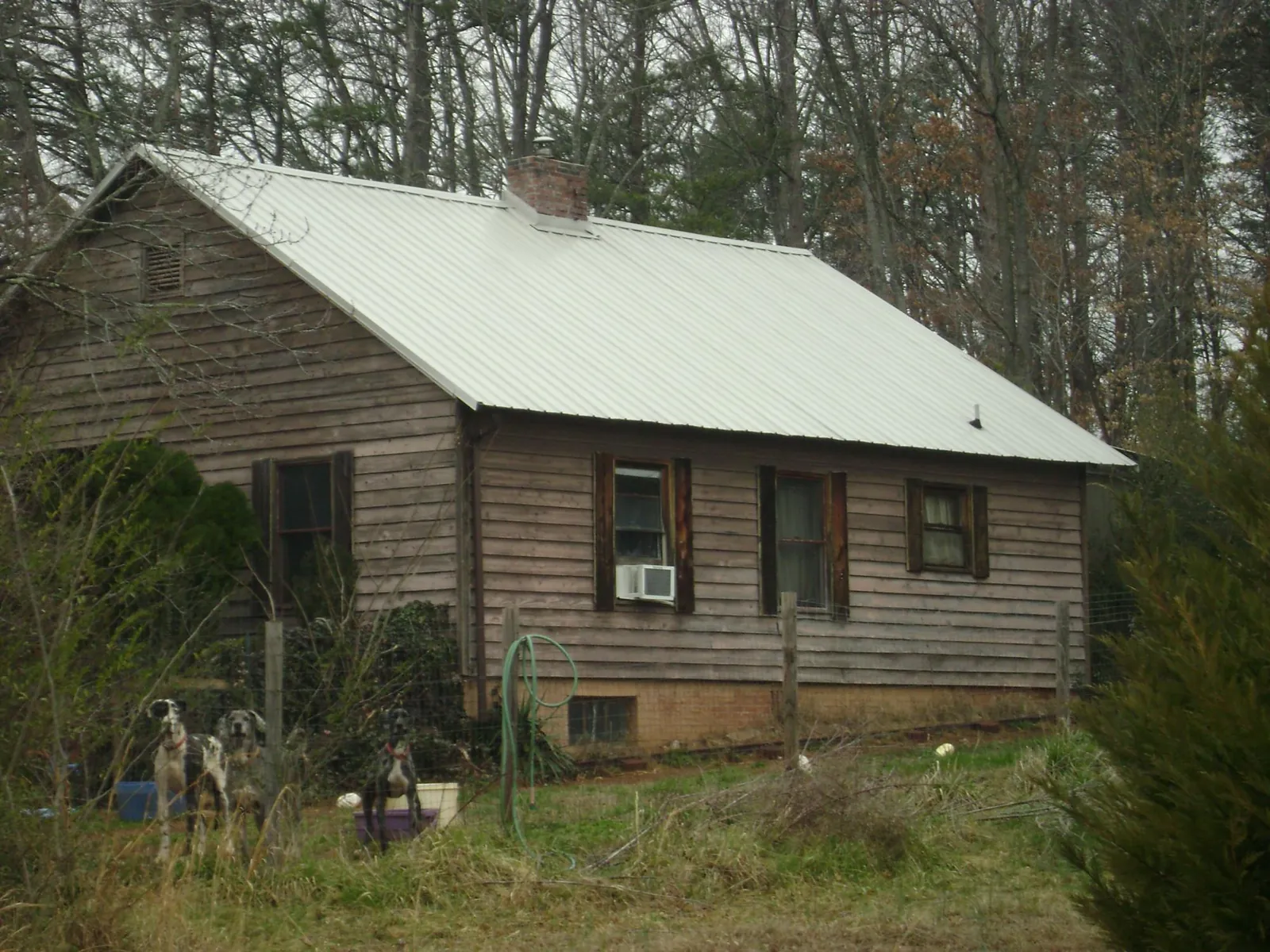White metal roof on an old wood sided farmhouse, from a Metal Roof Installation job in Topsham