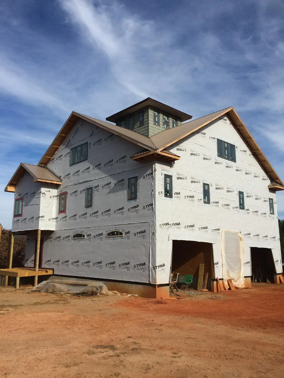 New two story house under construction with a cupola and gabled roofs in Topsham
